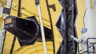 NASA technicians inspect the primary mirror of the James Webb Space Telescope. 