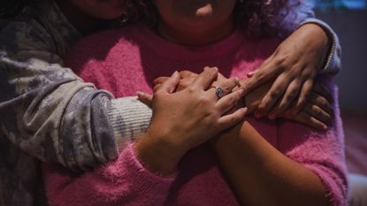 Close up of a young couple hugging - stock photo