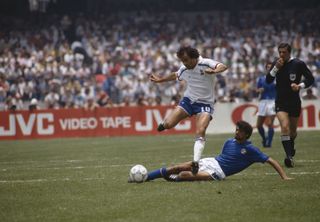 France's Michel Platini is tackled by Italy's Alesandro Altobelli at the 1986 World Cup.