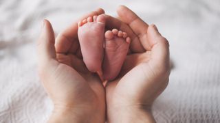 Feet of a newborn baby.