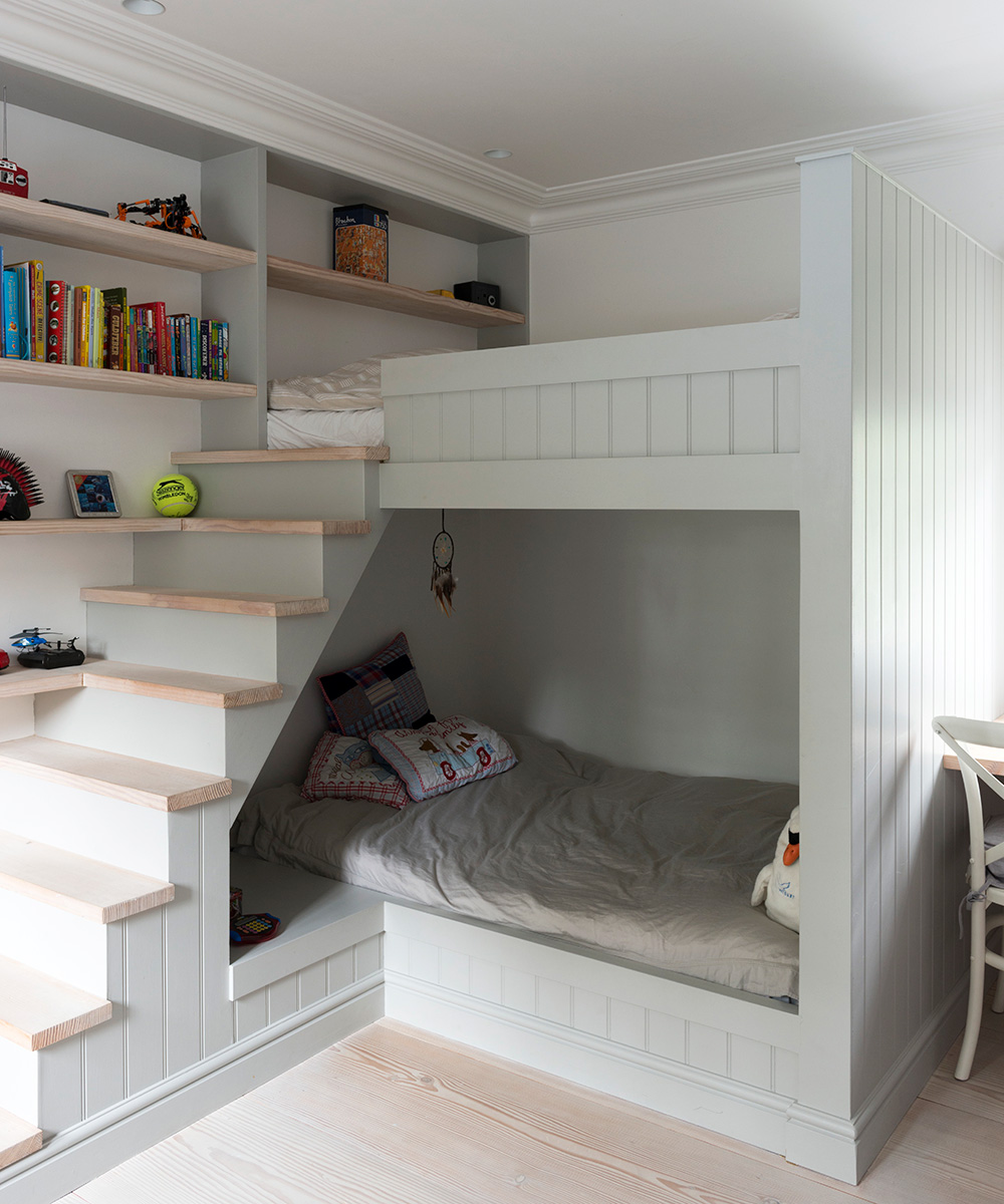 Bespoke bunk beds with steps and built-in shelving in a pale dove gray.