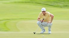 Cam Davis lines up his putt on the 18th green during the 3M Open.