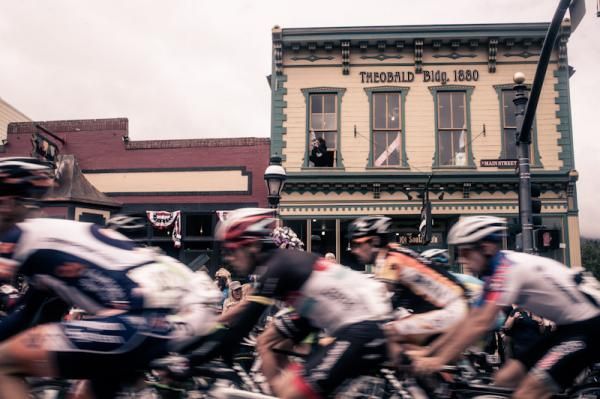 The USA Pro Challenge peloton passes some historic Colorado architecture.
