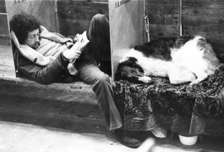 A dog owner and his dog have a rest at Crufts dog show at Earl's Court