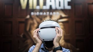 An attendee wears a Sony PlayStation VR2 (PS VR2) headset to play the Biohazard Village, known as Resident Evil Village outside of Japan, video game in the Capcom booth at the Tokyo Game Show 2022 on September 15, 2022 in Chiba, Japan.