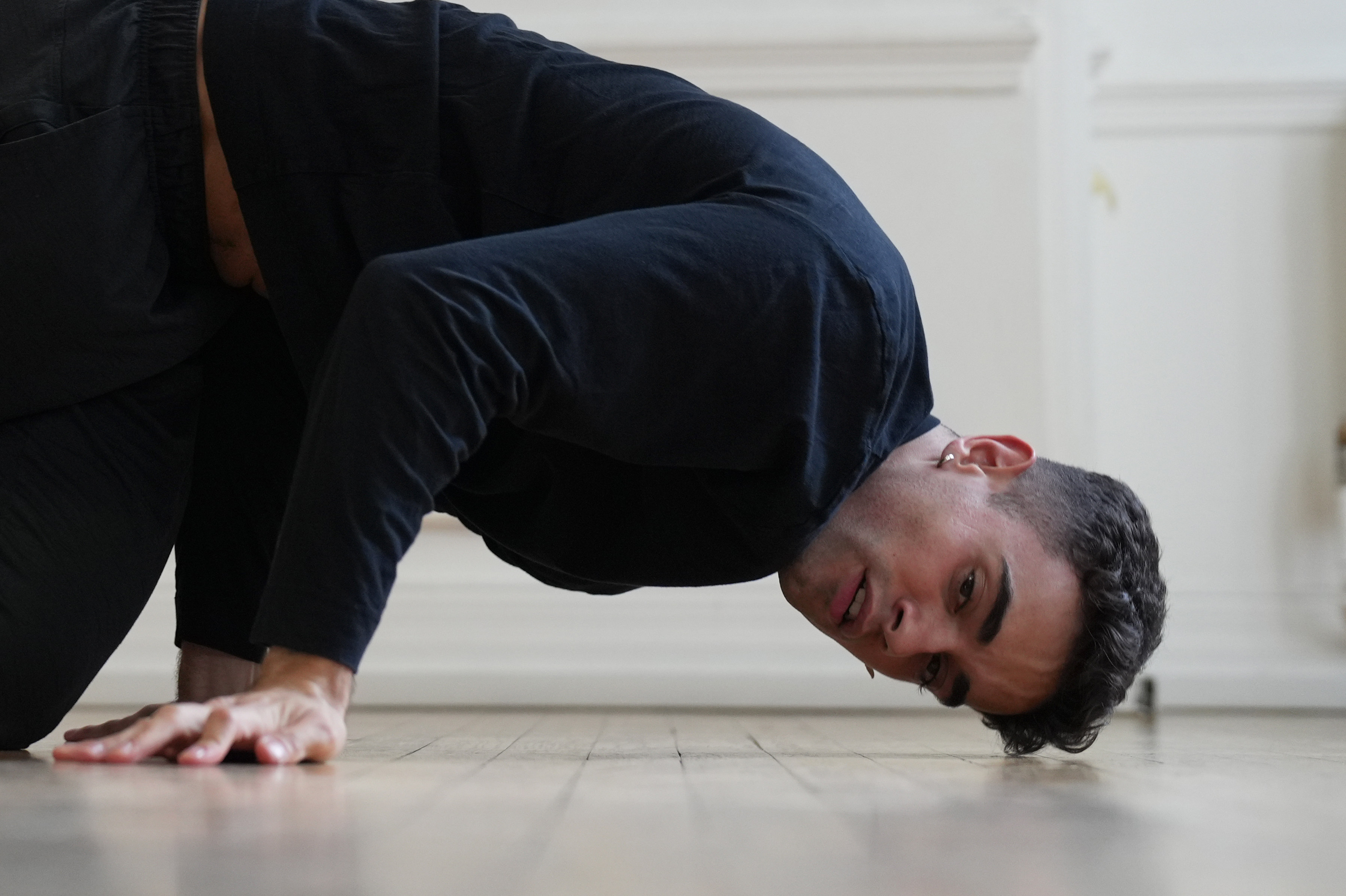 A man break dancing in a studio