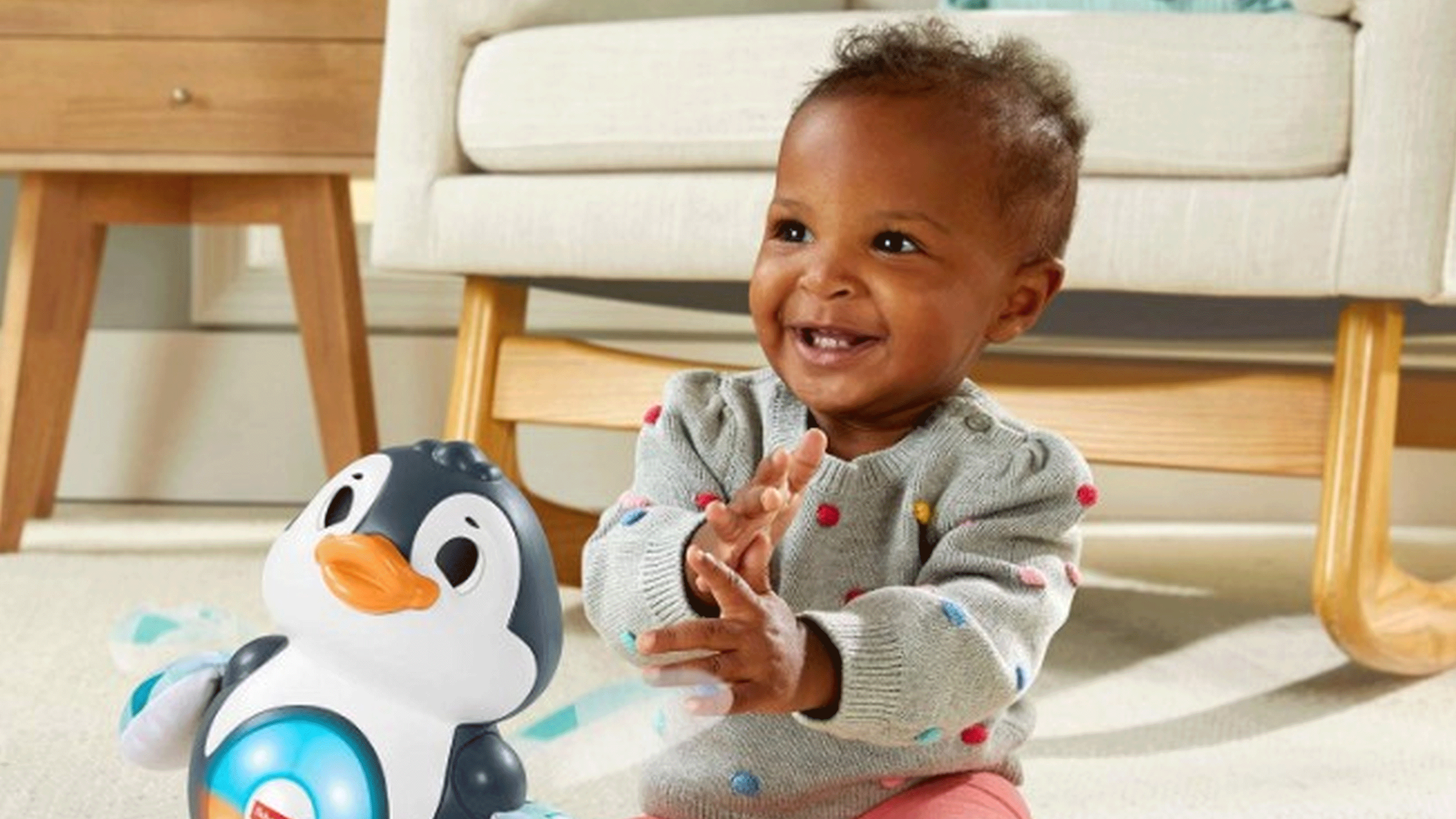 child playing with penguin toy from amazon