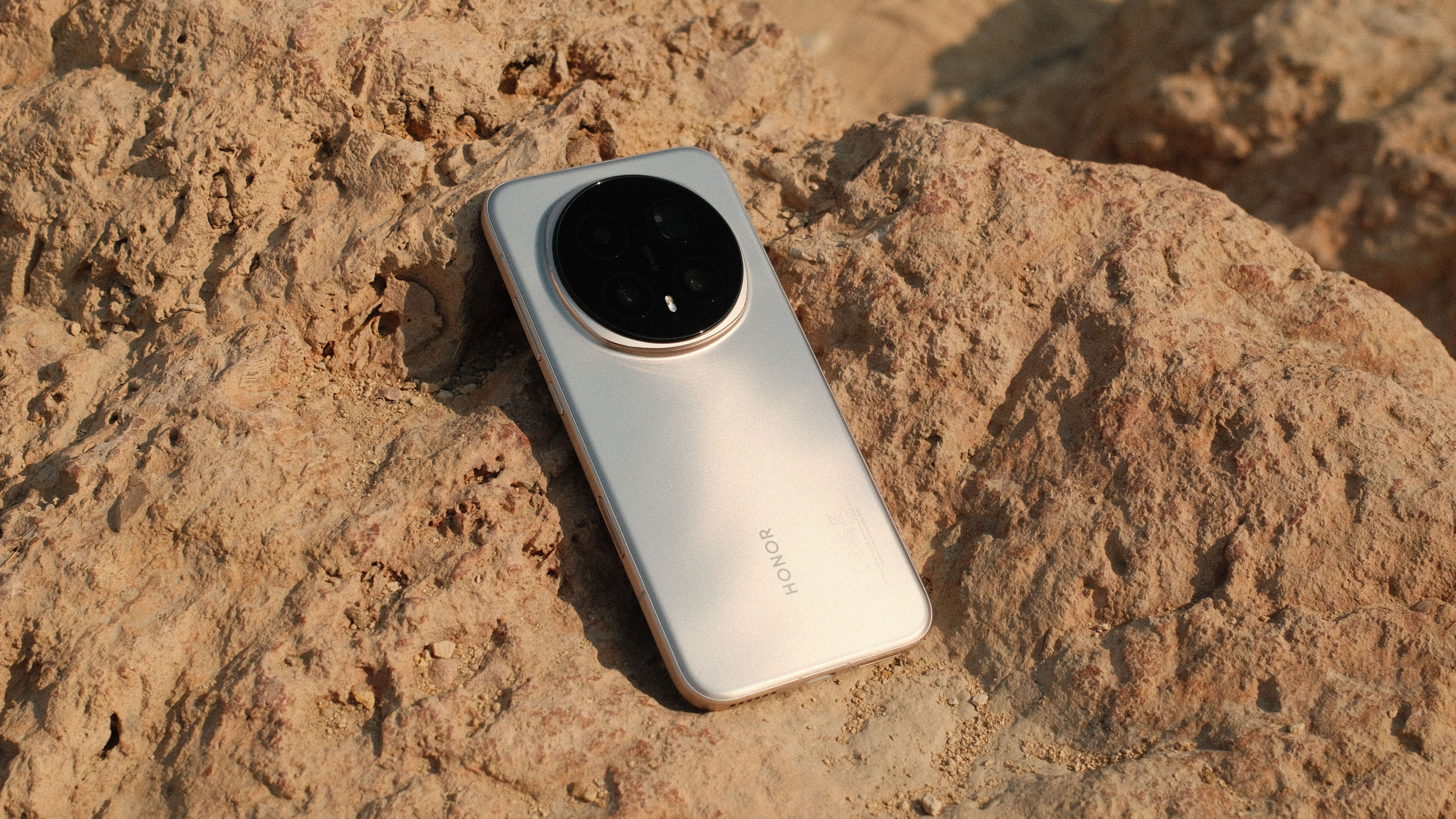 Honor Magic 8 Pro smartphone on a rock in the sun