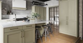 Industrial-style kitchen with sage green cabinets and white countertops with exposed brick walls and metal doors and exposed pipes supporting kitchen trends 2023