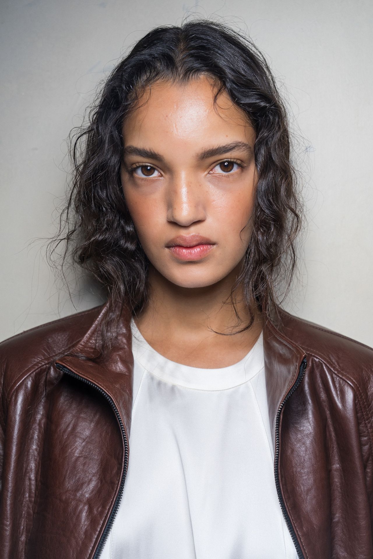 Three women with bronzed makeup