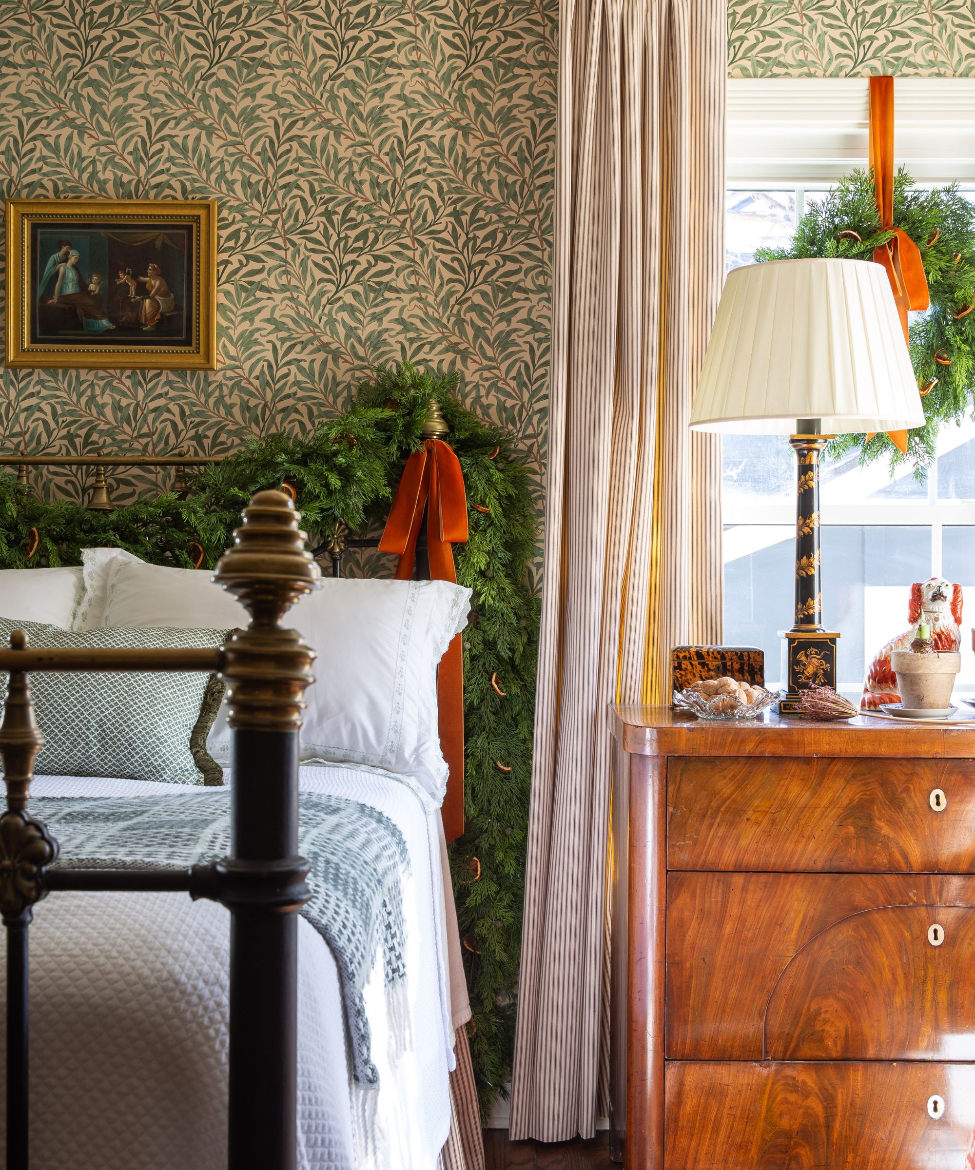 Bedroom with wrought iron bed and Morris &amp;amp; Co Willow Boughs wallpaper