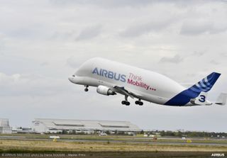 An Airbus Beluga takes off in Toulouse, France carrying the Eutelsat Hotbird 13G satellite.