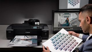 Capture to Fine Art Print: A complete pro workflow with Sanjay Jogia, image of Sanjay looking at contact sheet next to Canon Printer 