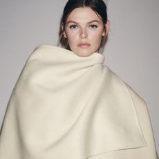 Woman wears beige wool coat from Zara