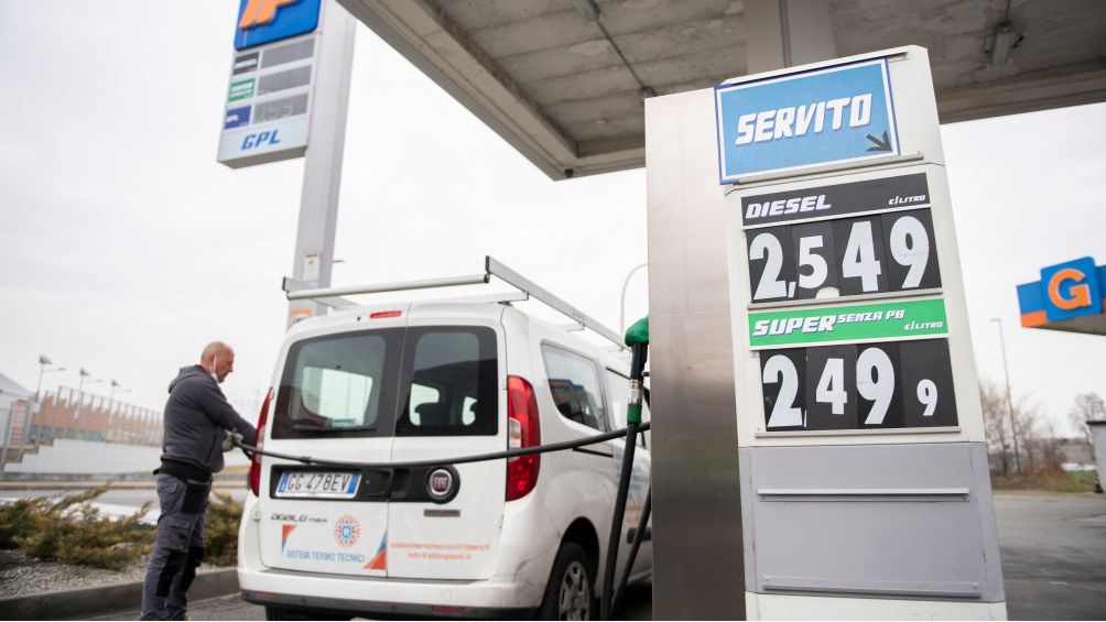 A person fills their car with gas at a gas station.