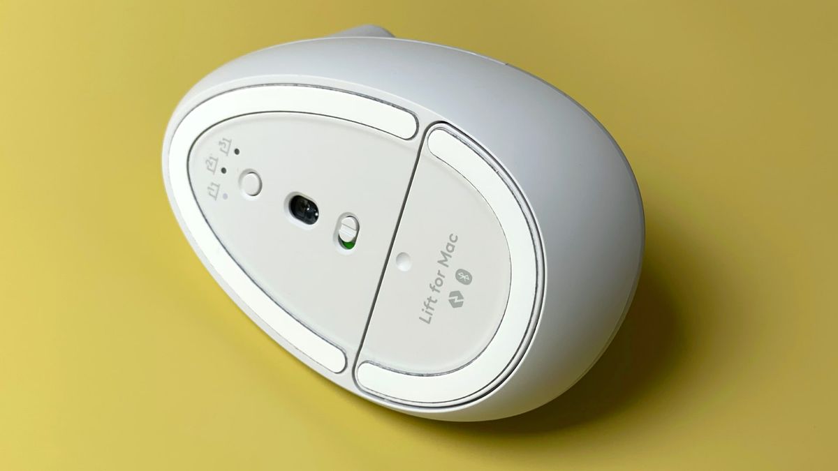 The Logitech Lift for Mac mouse against a yellow background.
