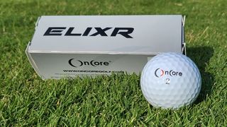 OnCore 2022 ELIXR Golf Ball resting on the golf course showing off its silver packaging