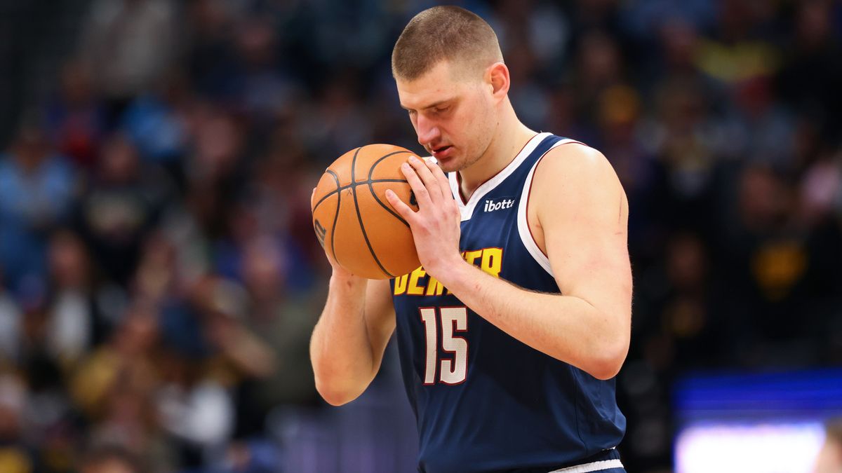 Nikola Jokic holds the basketball on court