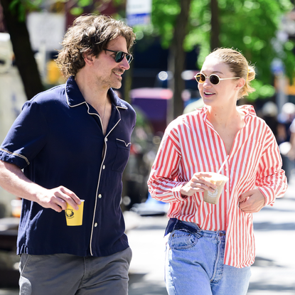 gigi hadid is seen on a coffee run with boyfriend bradley cooper wearing vintage jeans and a red striped button-down