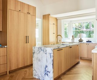 kitchen with wooden cabinets and marble island