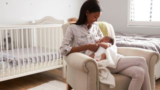 A mother holding her newborn in the nursery