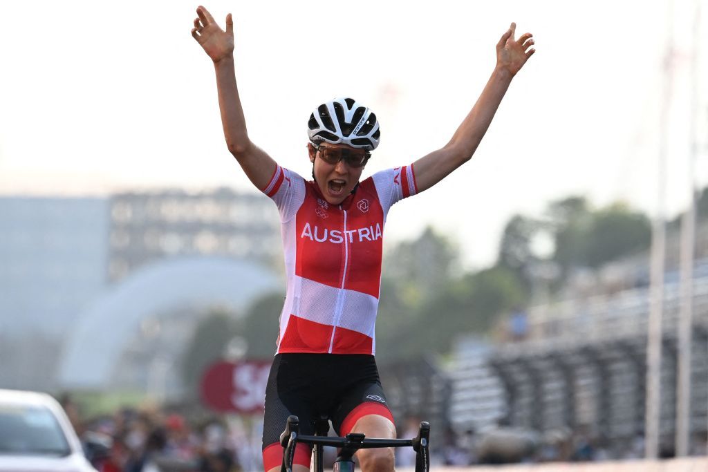 Austrias Anna Kiesenhofer celebrates as she crosses the finish line to win the womens cycling road race of the Tokyo 2020 Olympic Games at the Fuji International Speedway in Oyama Japan on July 25 2021 Photo by Greg Baker AFP Photo by GREG BAKERAFP via Getty Images