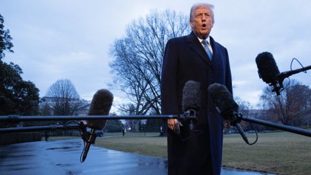 Donald Trump speaks to the press as he departs the White House en route to Mar-a-Lago last week 