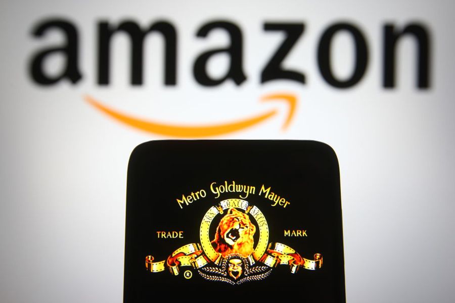 Metro-Goldwyn-Mayer (MGM) logo of US media company is seen on a smartphone screen with an Amazon logo in the background.