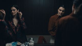 Rachel Weisz as Elliot and Beverly looking at themselves in the mirror getting ready.