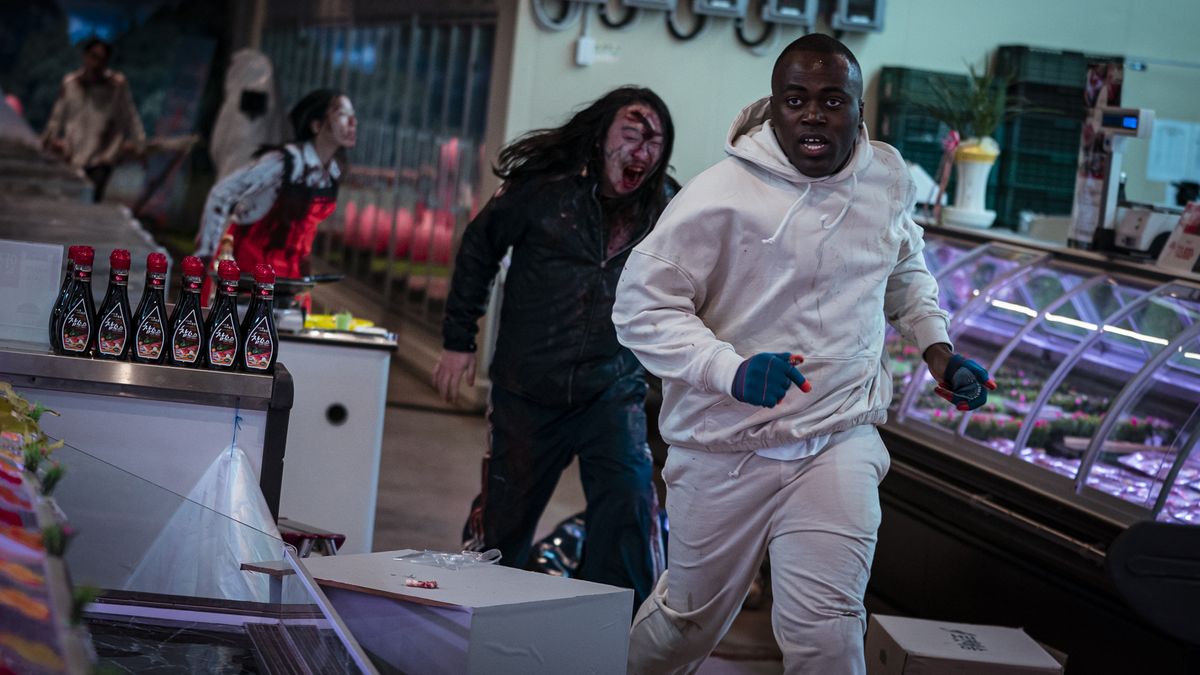 A contestant runs from some zombies in Netflix&#039;s Zombiverse reality TV show