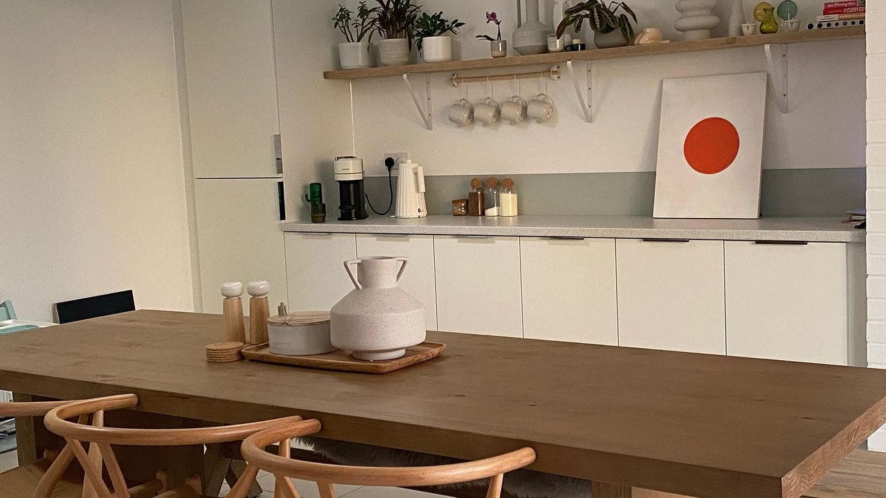 kitchen with wooden dining table and vases on table