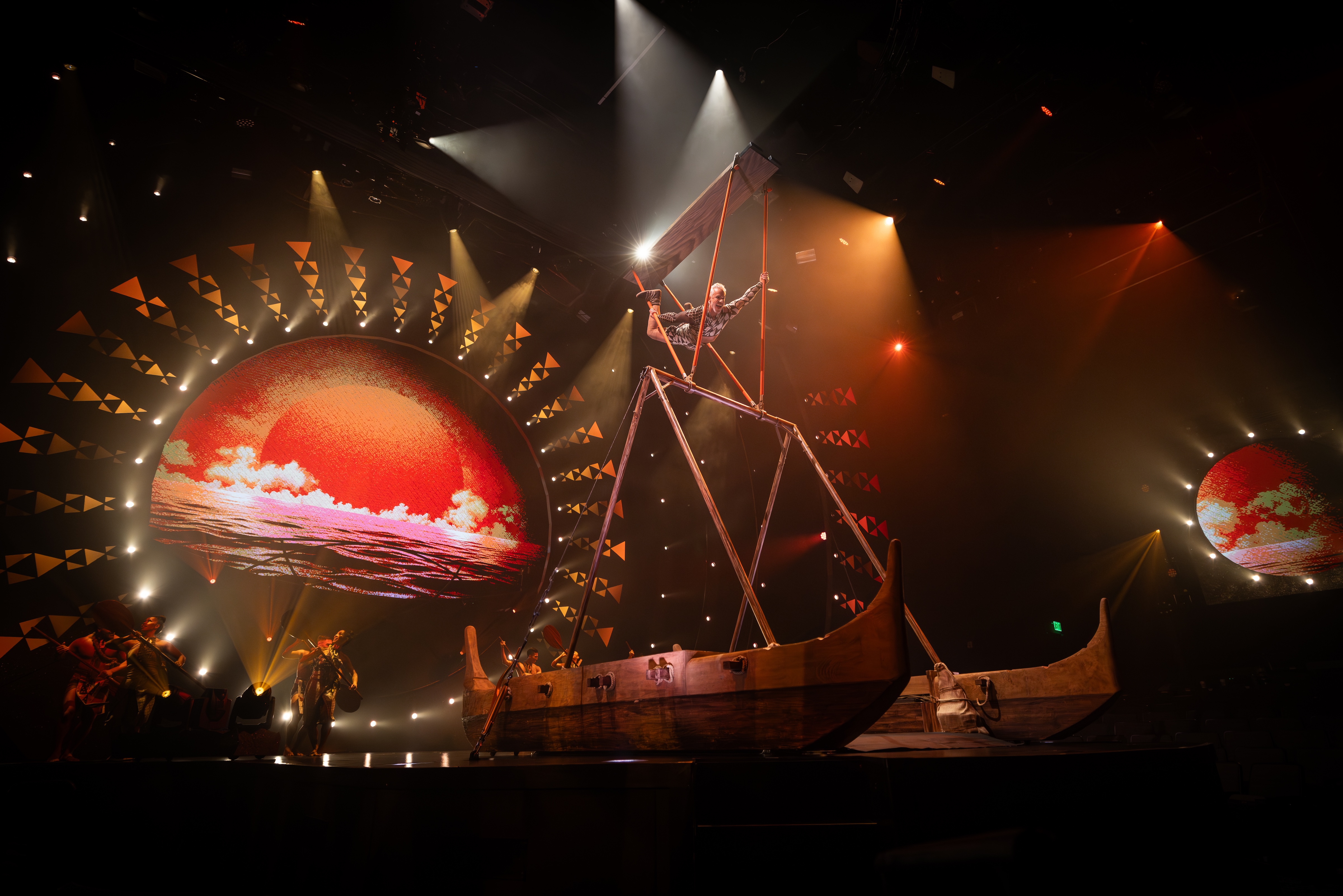 Cirque du Soleil performers on stage on a wooden boat