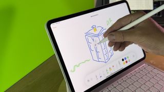 Apple Pencil Pro being used to write on an iPad screen