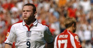 Portugal: England's forward Wayne Rooney (L) reacts after his goal in front of Switzerland's midfielder Christoph Spycher, 17 June 2004 at Coimbra's stadium, during their Euro 2004 group B football match at the European Nations championship in Portugal.
