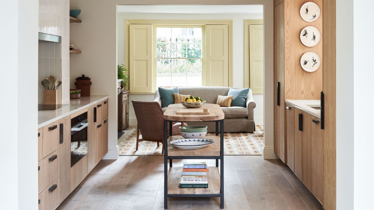 modern kitchen with wooden cabinets and floor and cream tiles