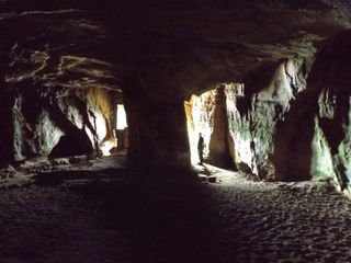 The twin entrance passages of the Sculptor's Cave led to a dread mortuary chamber where the ancient dead were left to rot.