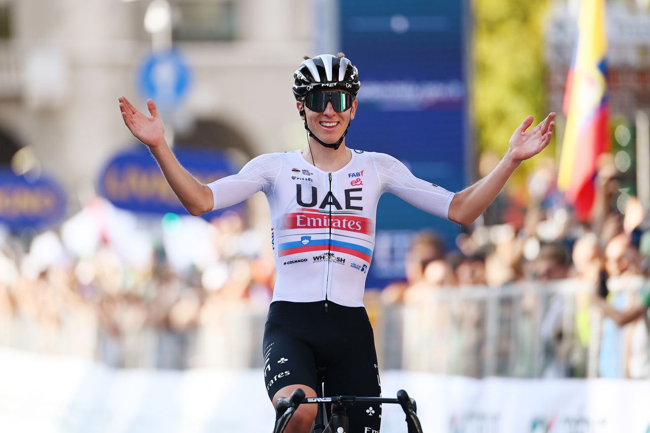 Tadej Pogačar celebrates as he wins Il Lombardia, with hair tufts visible