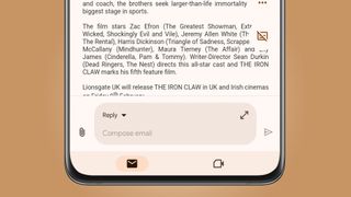 An Android phone on a beige background showing the new Reply box in the Gmail app