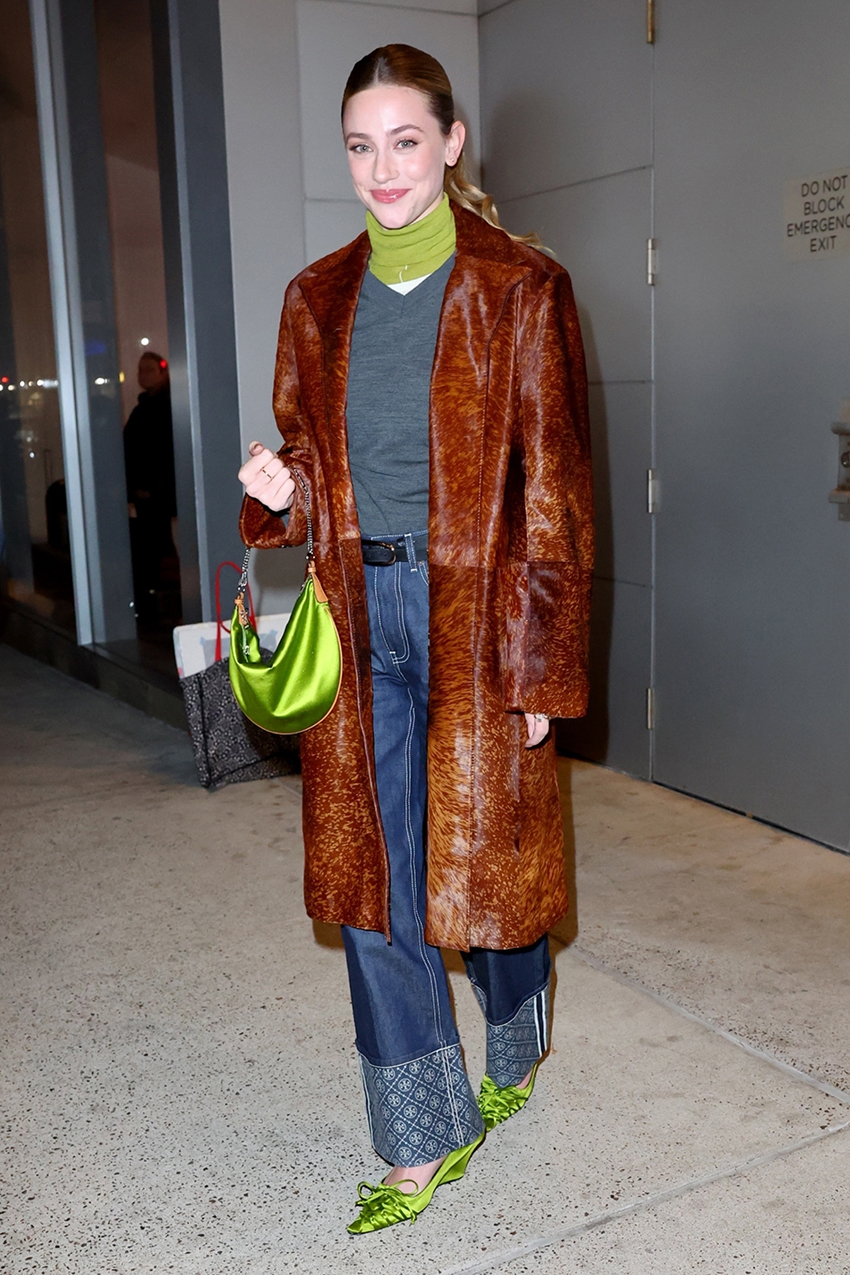 Lili Reinhart wearing a leather coat, jeans, and lime green accessories