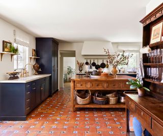 kitchen with original tiles and blue cabinets wooden island