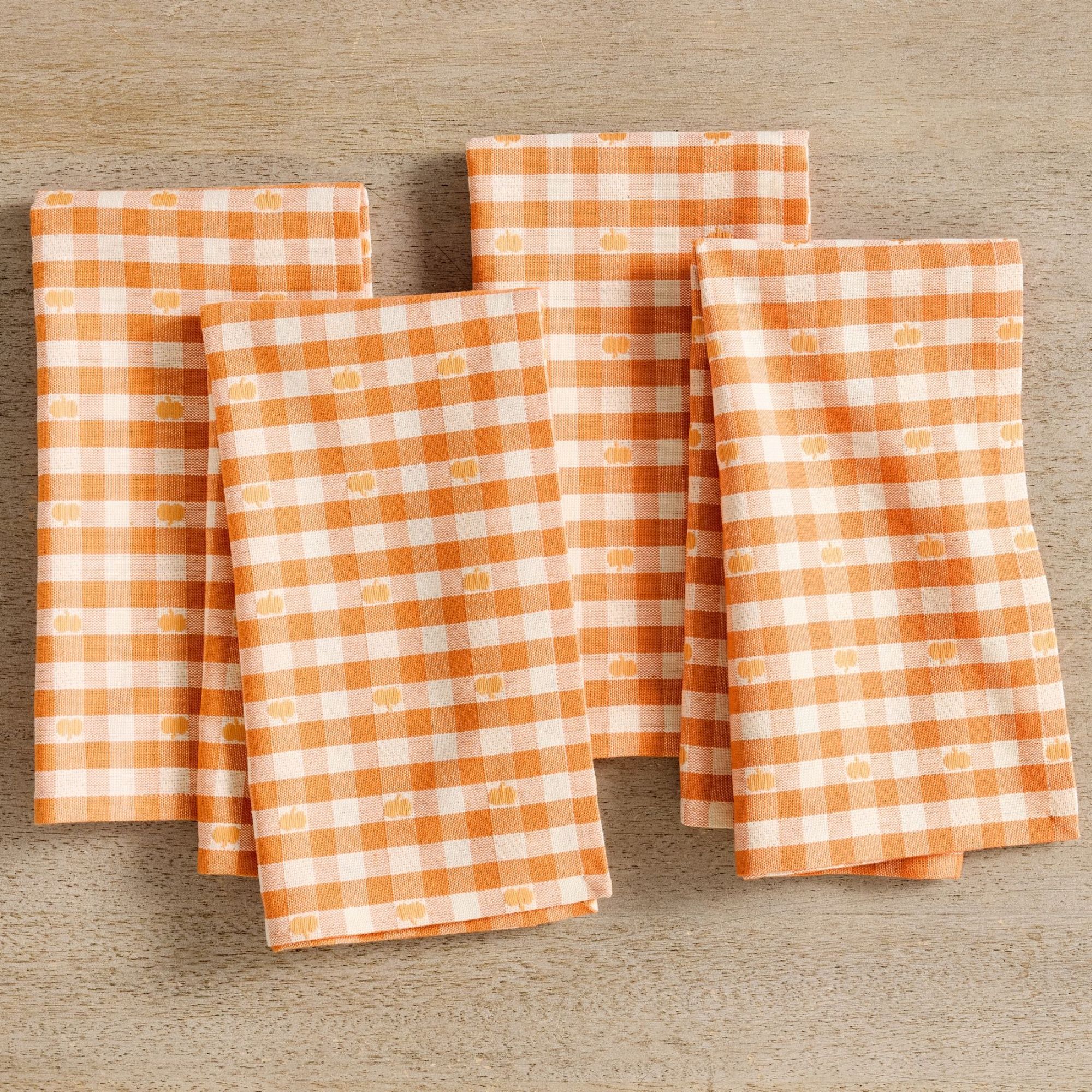 Orange and white gingham napkins with small pumpkin motifs