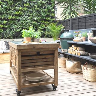 moveable island in outdoor kitchen area on decked space