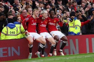 Alejandro Garnacho of Manchester United celebrates with Rasmus Hojlund and Kobbie Mainoo of Manchester United after scoring his team's second goal during the Premier League match between Manchester United and West Ham United at Old Trafford on February 04, 2024 in Manchester, England.