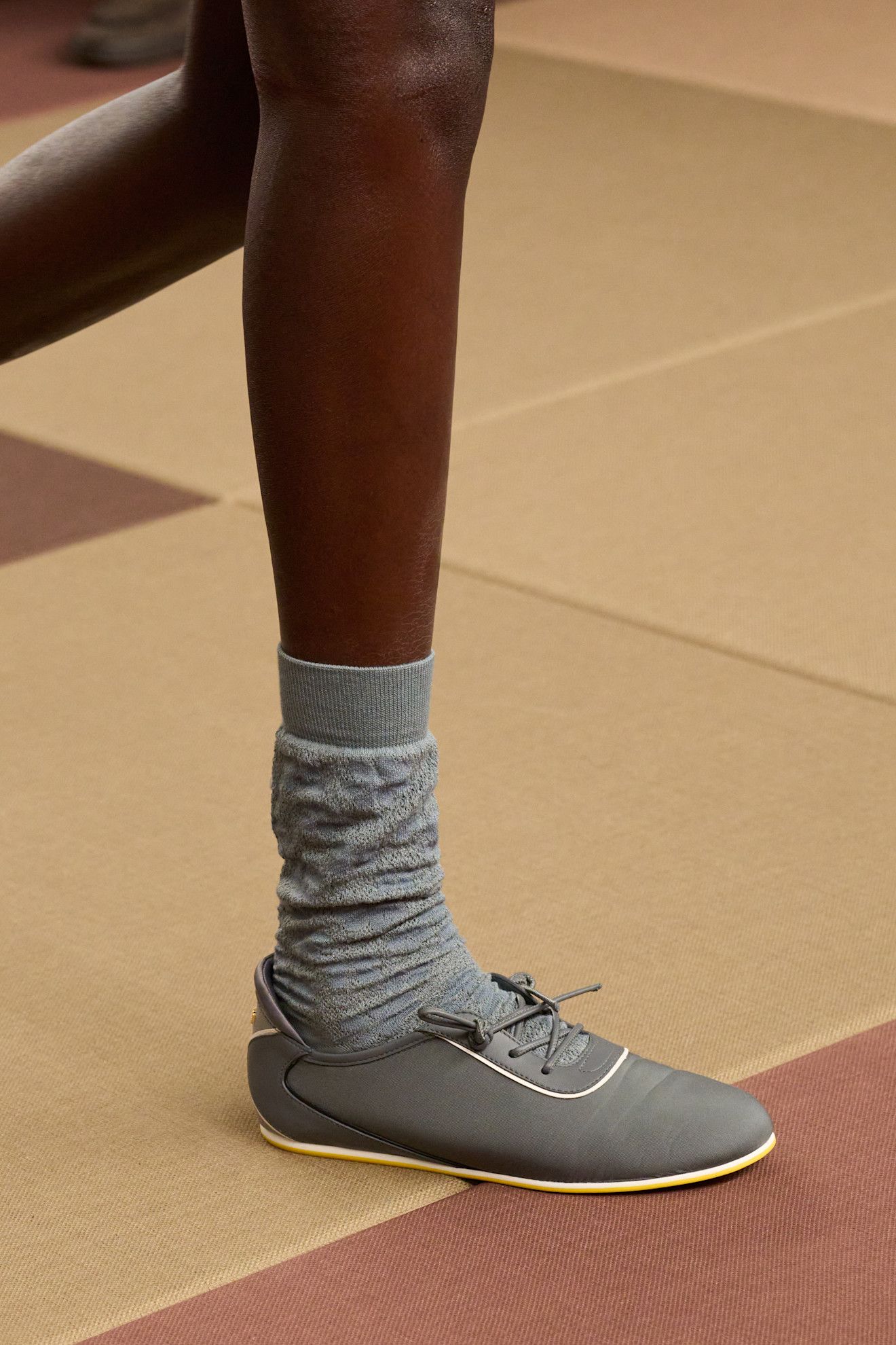 a detail image showing a pair of grey hybrid sneakers on the Fendi spring 2026 runway during Milan Fashion Week