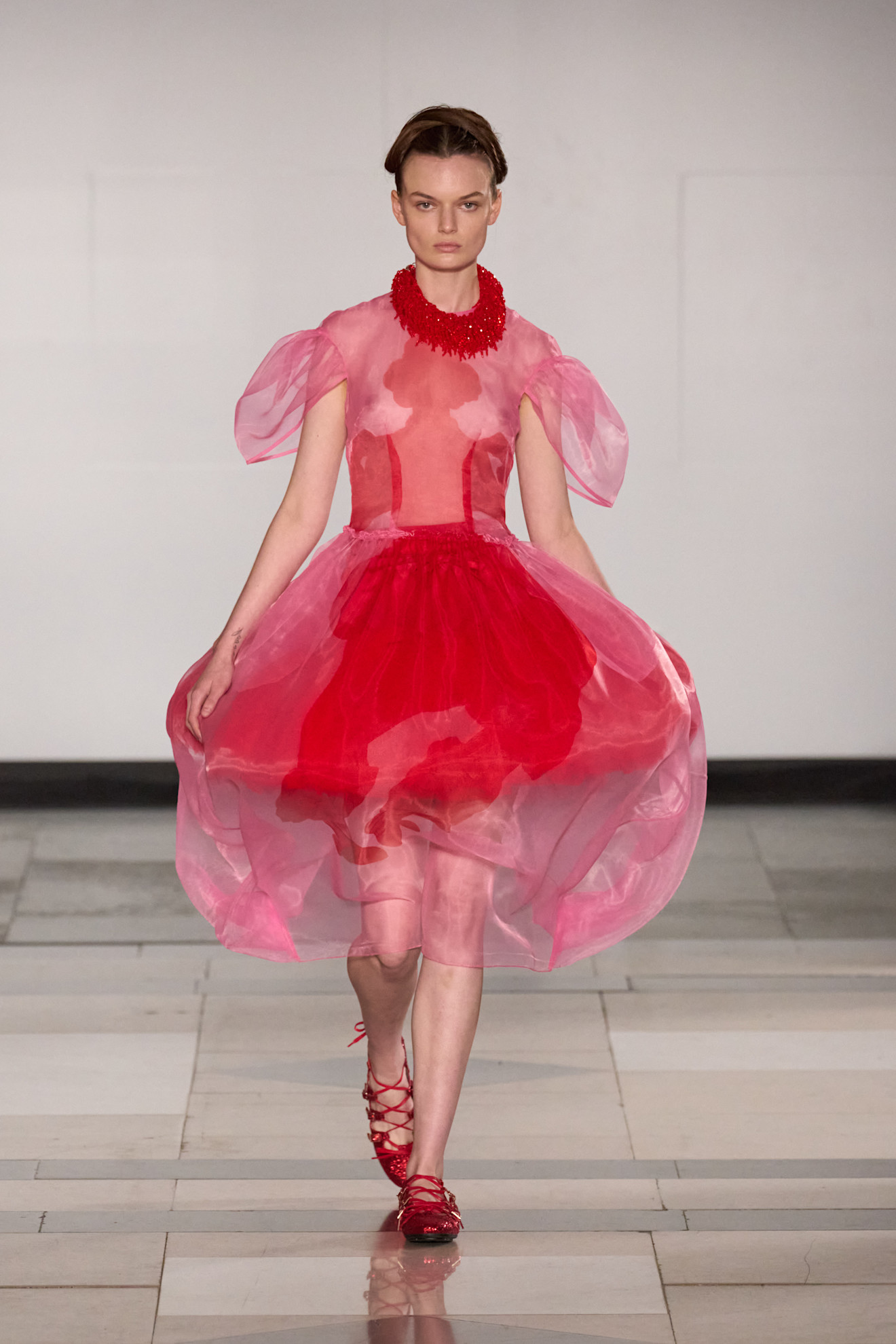 An image of lace-up flats on the Simone Rocha runway.