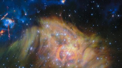 A swirling landscape of dust and dwarf stars in one of the largest JWST photos ever released