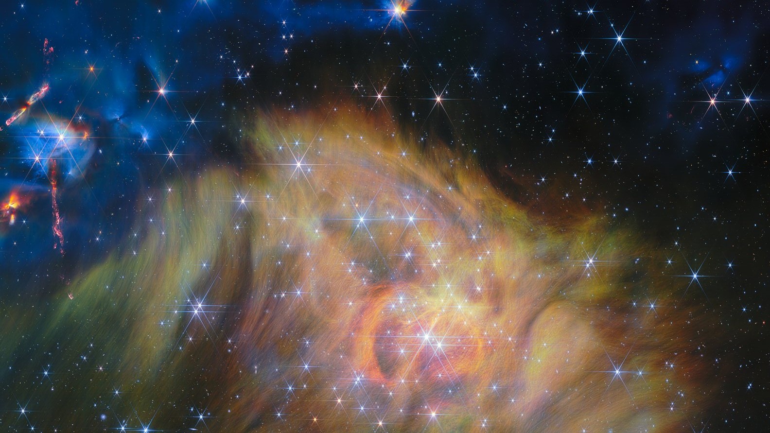 A swirling landscape of dust and dwarf stars in one of the largest JWST photos ever released