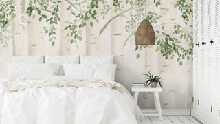 white bedroom with sage green painted leafy wall mural