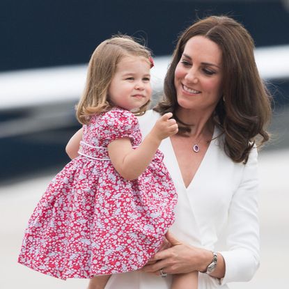 The Princess of Wales holding Princess Charlotte as they arrive in Warsaw, Poland