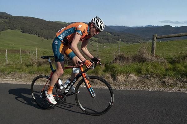 Dylan Newell (Genesys Wealth Advisers) climbing at Gunns Plains whilst a little snow remains on the mountains in the distance.